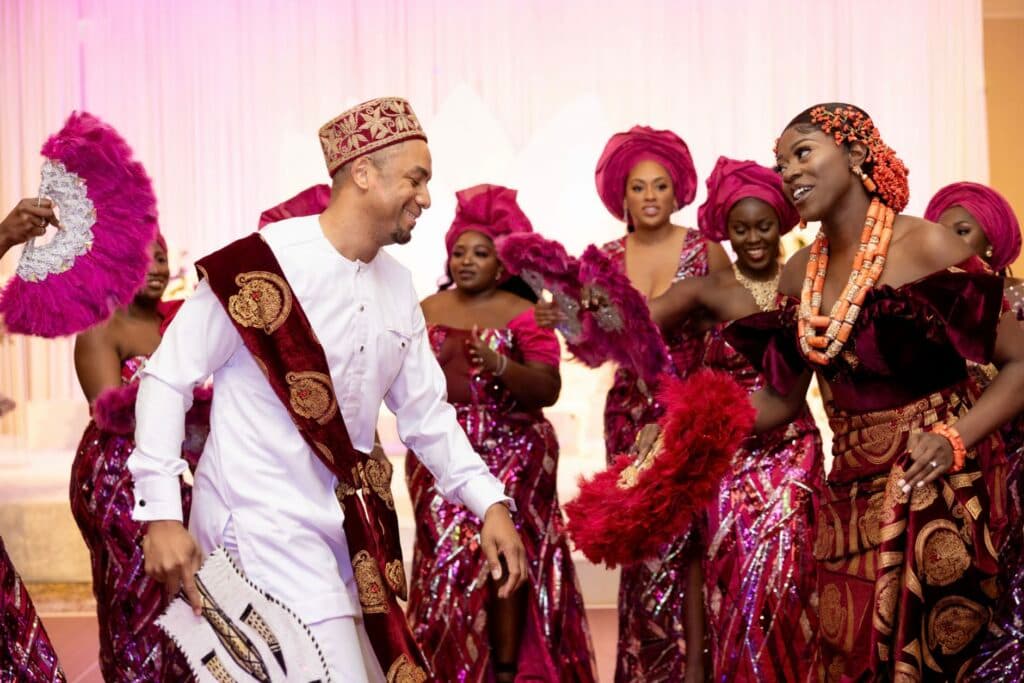 A couple joyfully dancing at their traditional Nigerian wedding